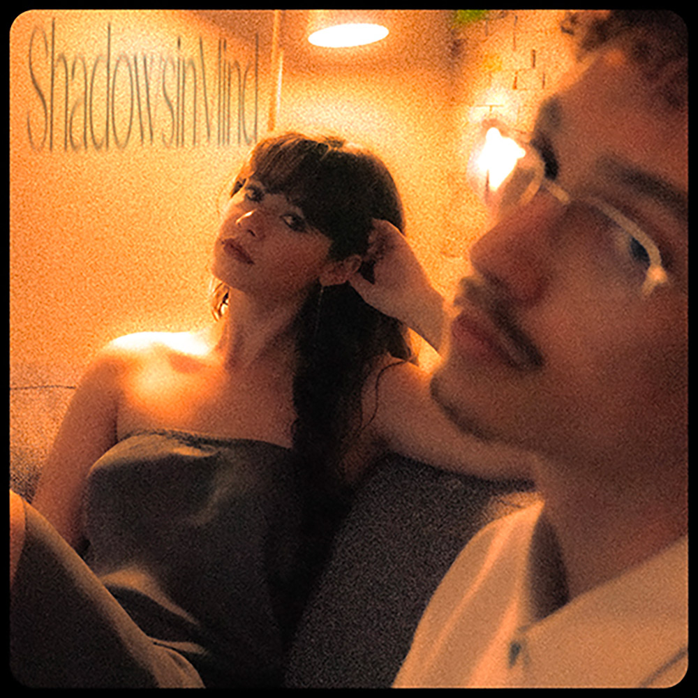 Swiss artist AZURE seated with Noa Emien. Single Shadowsinmind cover art.