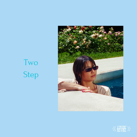 Azure, Swiss artist, posing on the edge of a pool wearing sunglasses. Single Two Step official album cover in light blue background.